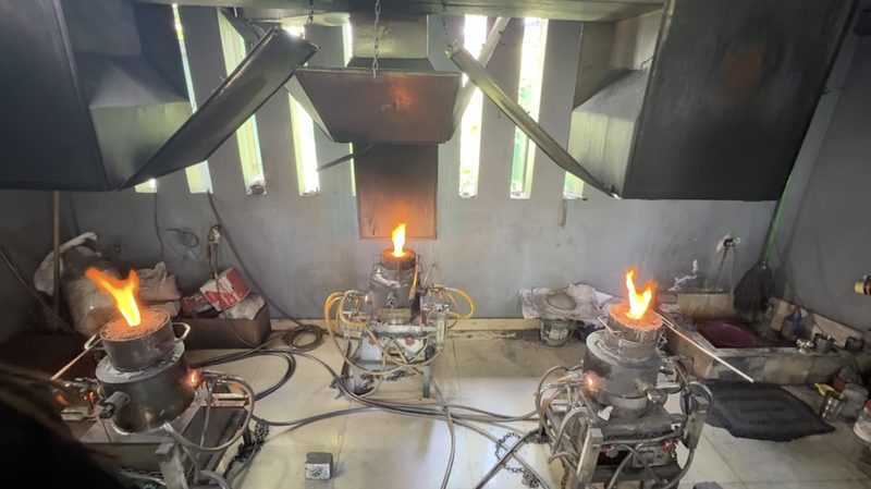 Three sapphire heat-treatment furnaces with open flames in a workshop in Sri Lanka