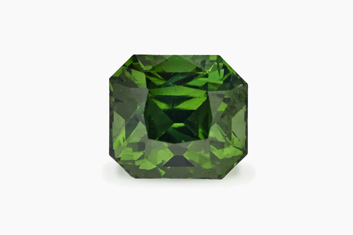 A green zircon, octagonal cut, photographed on a white background